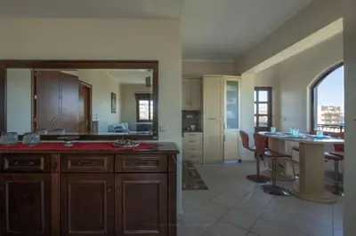 a large kitchen with a table and a dining room at Terpsis House in Kissamos