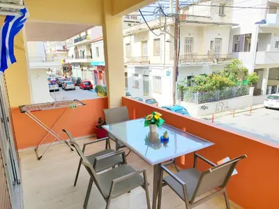 a table and chairs on a balcony with a view of a street at Marlen House Chania in Chania Town