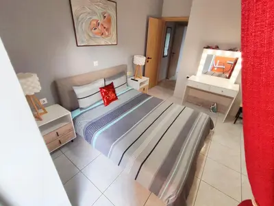 a bedroom with a large bed with a red pillow at Marlen House Chania in Chania Town