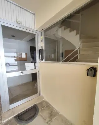 a sliding glass door in a room with a staircase at Marlen House Chania in Chania Town