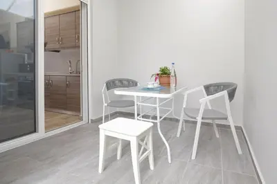 a white table and chairs in a kitchen at Captain Nick in Chania Town