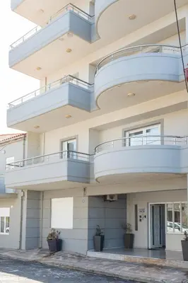 an apartment building with balconies and potted plants at Captain Nick in Chania Town