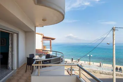 a balcony with a view of the ocean at Captain Nick in Chania Town
