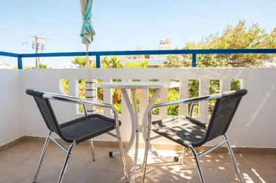 two chairs and a table on a balcony at Anthea Apartments in Palaiochóra