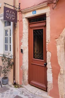 a red door on the side of a building at Alegria Pension in Chania Town