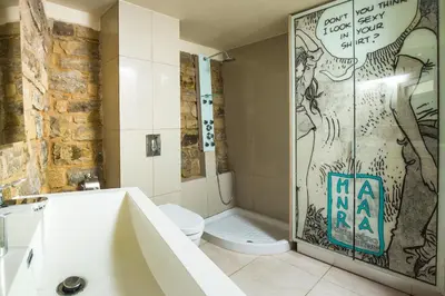 a bathroom with a sink and a toilet and a shower at Larimar Luxury Sea View Villa in Kissamos