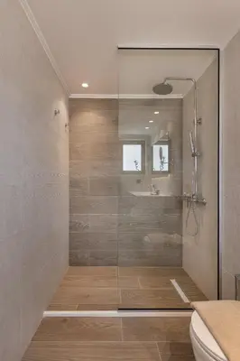 a shower with a glass door in a bathroom at Mossa Well Being Hotel - Heated pool and Wellness Spa in Kato Daratso