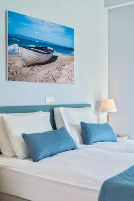 a bedroom with a bed with a boat on it at Celestine Suites in Kolymvari