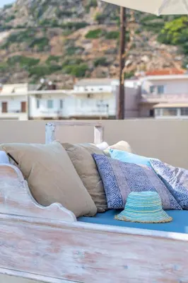 a pile of pillows sitting on top of a bed at Celestine Suites in Kolymvari