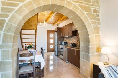 an archway in a kitchen with a table and chairs at Platania's Horizon in Plataniás