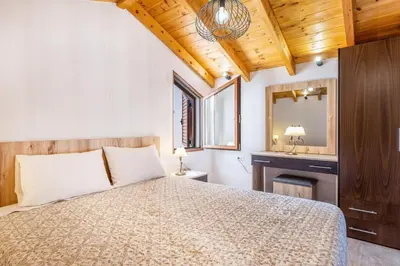 a bedroom with a large bed and a mirror at Platania's Horizon in Plataniás