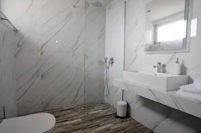 a white bathroom with a sink and a toilet at Southern Paradise Villas - Private Pool in Kalamaki Chanion