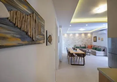 a living room with a table and a couch at Southern Paradise Villas - Private Pool in Kalamaki Chanion