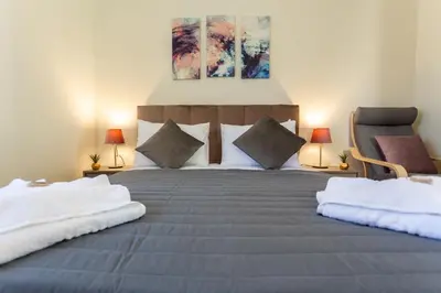 a bedroom with a large bed with two pillows at Creta Galini House in Sirílion