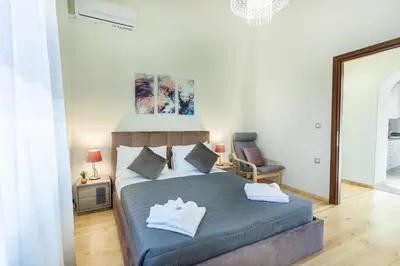 a bedroom with a king sized bed and a chair at Creta Galini House in Sirílion