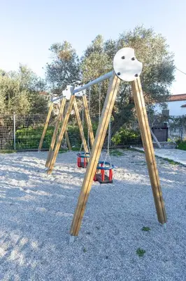 a pair of swings in a park at Creta Galini House in Sirílion