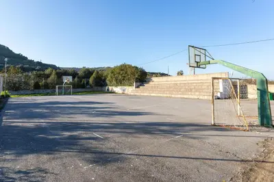 an empty parking lot with a basketball hoop at Creta Galini House in Sirílion