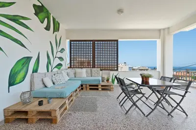 a living room with a couch and a table at Sea City and Mountain View Apartment in Chania Town