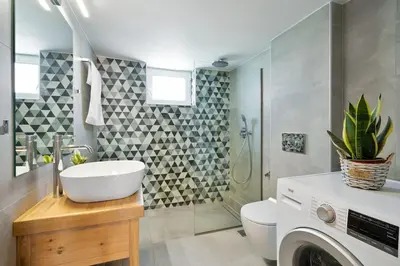 a bathroom with a sink and a washing machine at Sea City and Mountain View Apartment in Chania Town