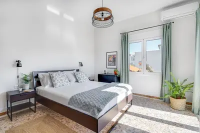 a bedroom with a bed and a window at Sea City and Mountain View Apartment in Chania Town