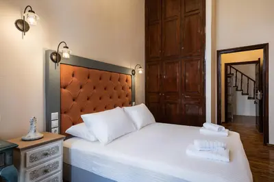 a bedroom with a bed with two towels on it at Old Town Suites in Chania Town