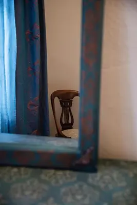 a reflection of a chair in a mirror at Old Town Suites in Chania Town