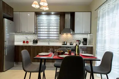 a kitchen with a table and chairs in a kitchen at Castello Villa - Seaview Villa atop the Venetian Walls in Kissamos