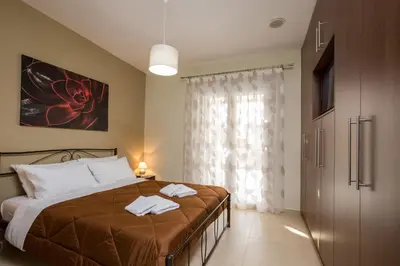 a bedroom with a bed with two towels on it at Castello Villa - Seaview Villa atop the Venetian Walls in Kissamos