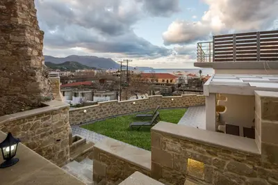 a view from the roof of a building with a bench at Castello Villa - Seaview Villa atop the Venetian Walls in Kissamos