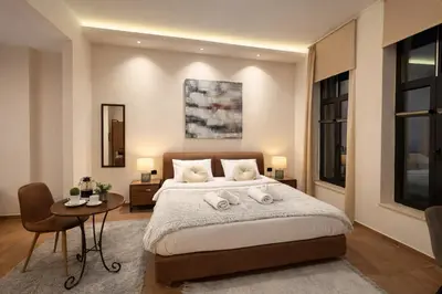 a bedroom with a bed with two towels on it at Endless Blue Suites in Chania Town