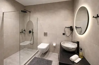 a bathroom with a sink and a toilet and a mirror at Endless Blue Suites in Chania Town