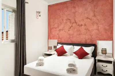 a bedroom with two beds with red pillows at Vista del Puerto in Chania Town