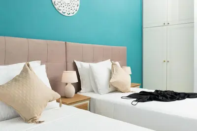 two beds sitting next to each other in a bedroom at Vista del Puerto in Chania Town