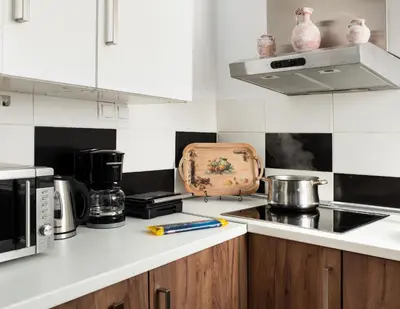 a kitchen with black and white tiles on the wall at Vista del Puerto in Chania Town