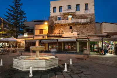 a fountain in the middle of a street with a building at Vista del Puerto in Chania Town