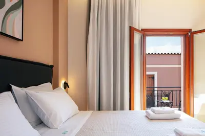 a bedroom with a bed with a view of a balcony at Centro Storico in Chania Town
