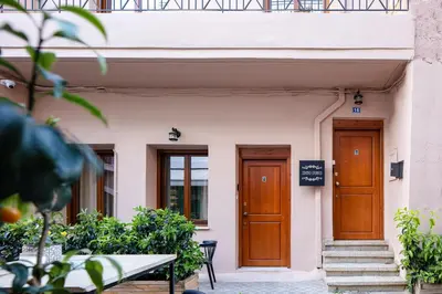 a building with two wooden doors and a table at Centro Storico in Chania Town