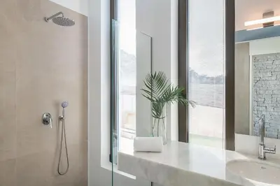 a bathroom with a sink and a shower with a glass door at Ellas Residence fantastic pool heated in Kissamos