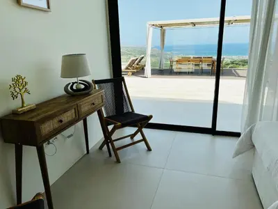 a bedroom with a desk and a chair and a window at Ellas Residence fantastic pool heated in Kissamos