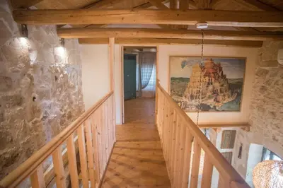 a staircase in a house with a painting on the wall at Old stone villa in Apokoronas Villa Nostalgia Kreta in Fílippos