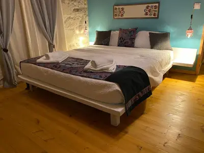 a bed with two towels on it in a room at Old stone villa in Apokoronas Villa Nostalgia Kreta in Fílippos