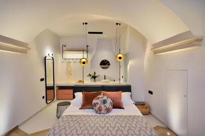 a bedroom with a large bed and a bathroom at Neorion Living in Chania Town