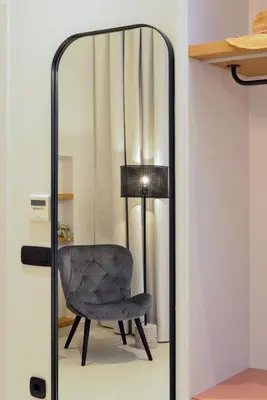 a mirror with a chair and a lamp at Neorion Living in Chania Town