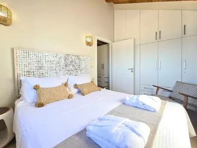 a bedroom with a large white bed with two pillows at Seastar seafront villa in Kalamaki Chanion