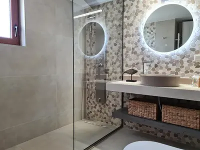 a bathroom with a sink and a mirror at Seastar seafront villa in Kalamaki Chanion