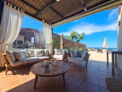 a living room with a couch and chairs and a table at Seastar seafront villa in Kalamaki Chanion