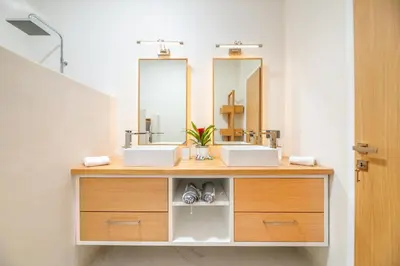 a bathroom with two sinks and a mirror at Villa Evrithea in Kalleryianá