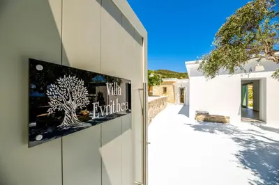 a building with a sign on the side of it at Villa Evrithea in Kalleryianá