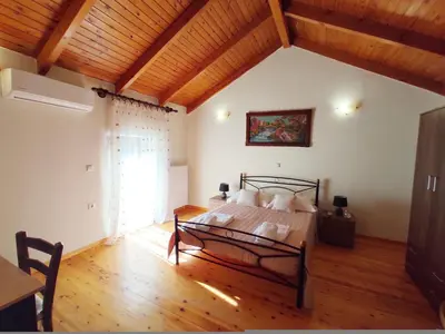 a bedroom with a bed and a wooden ceiling at Traditional Stone House Rafael in Tzitzifés