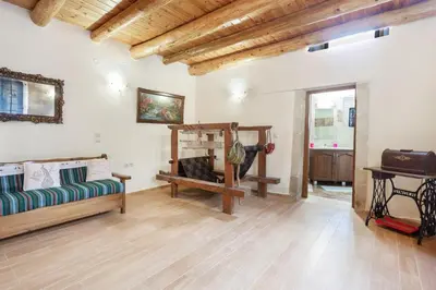 a living room with a couch and a table at Traditional Stone House Rafael in Tzitzifés